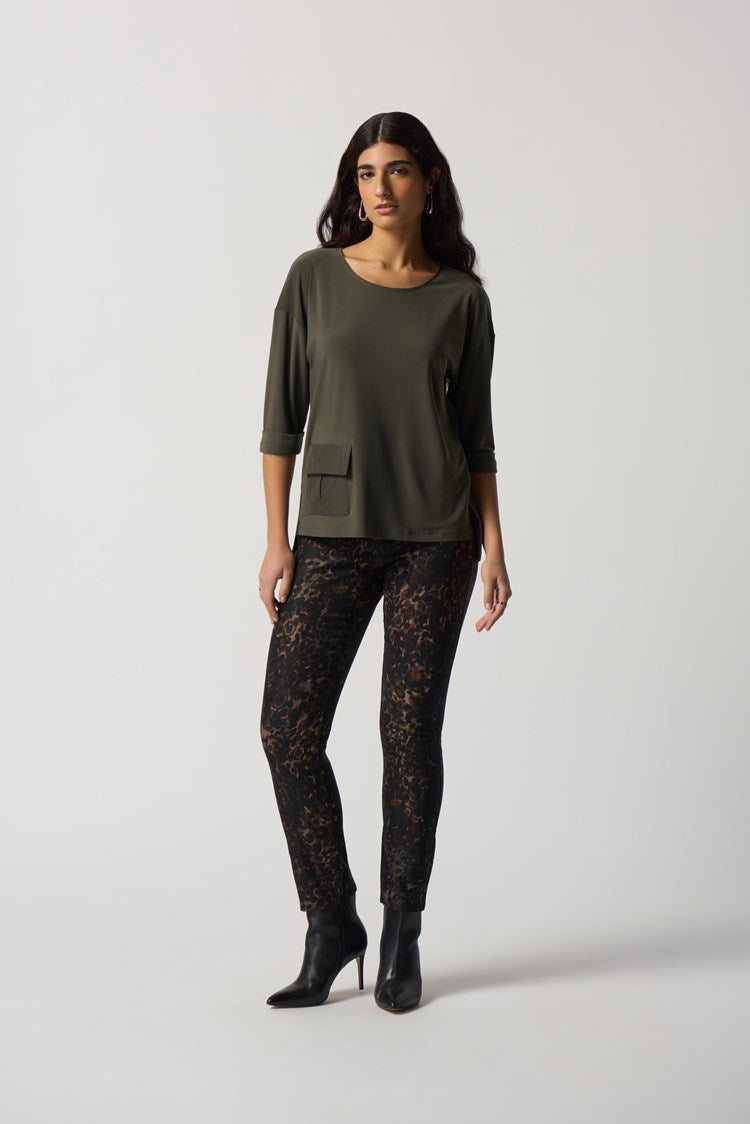 This lovely Joseph Ribkoff Dolman Sleeve Boxy Top is made in a smooth woven fabric creates this silky knit top. Intentional design features include boxy silhouette, three-quarter dolman sleeves and folded cuffs. A practical side pocket rounds out the look that is perfect to wear dressed up or casual with jeans.