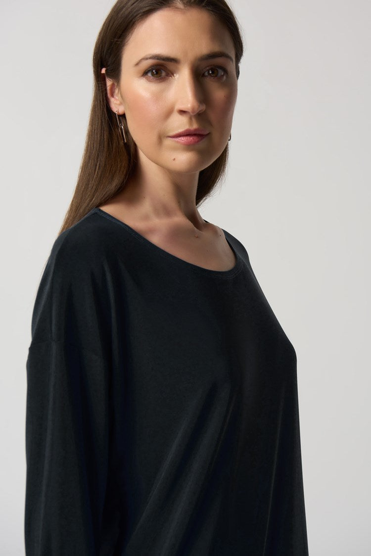 This lovely Joseph Ribkoff Dolman Sleeve Boxy Top is made in a smooth woven fabric creates this silky knit top. Intentional design features include boxy silhouette, three-quarter dolman sleeves and folded cuffs. A practical side pocket rounds out the look that is perfect to wear dressed up or casual with jeans.