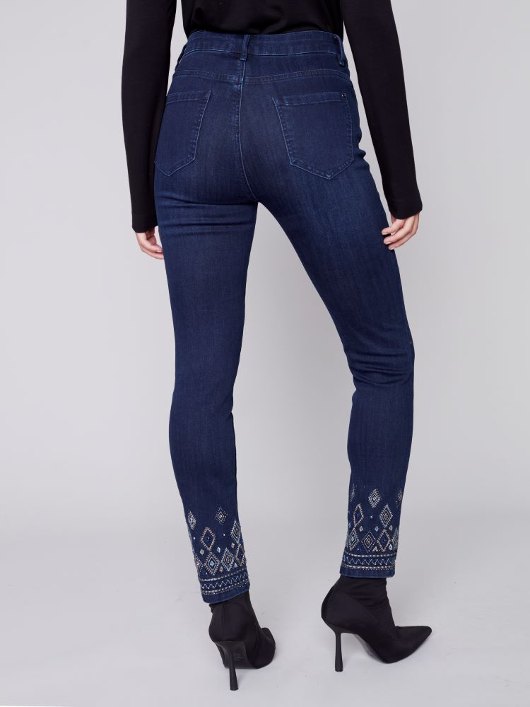 Elevate your seasonal wardrobe with Charlie B's Blue Black jeans. Exquisite geometric embroidery and embellishments adorn the hem, while a slim leg, regular rise and stretch material provide a comfortable fit with five convenient pockets.