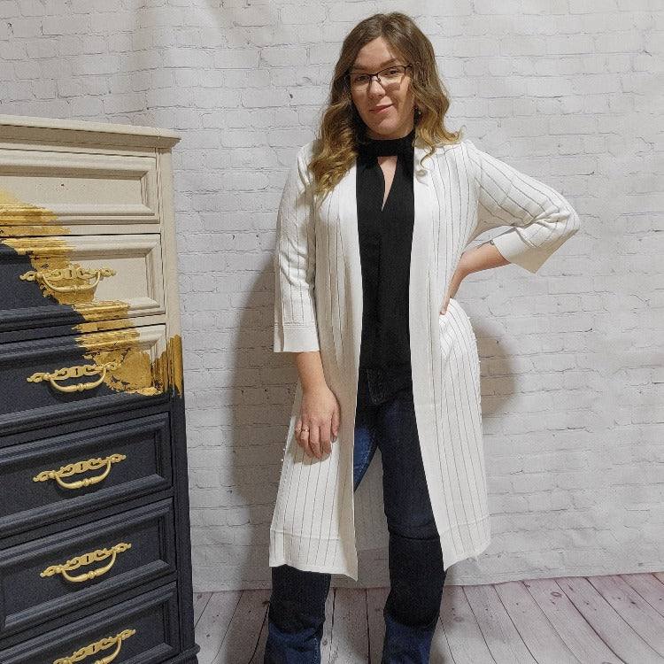 Comfortable and flattering this Joseph Ribkoff Long Cardigan will become a go to for you. The open front is perfect to show off your style and the side slits have studs along the edge for an edgy look that you can toss on over a casual or dressy style.