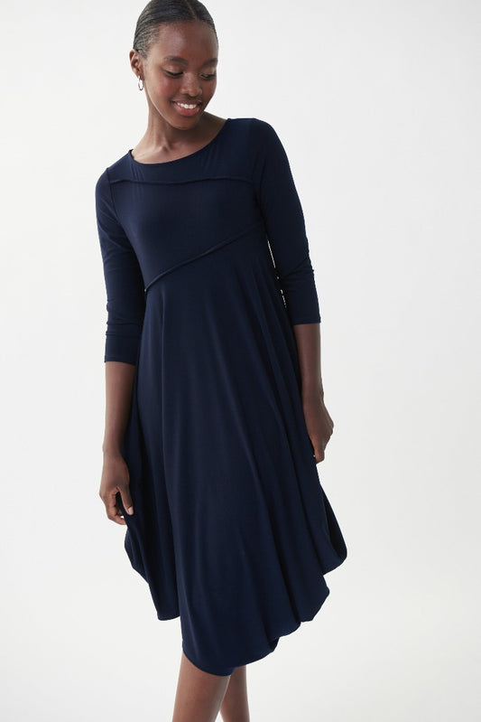 This Joseph Ribkoff Sleeveless Flowy Dress is an easy piece you'll love to wear again and again. With unique stitching on the bodice and arms, convenient 3/4 length sleeves and an angled, bubble-style hemline, this basic is the perfect throw-on dress.