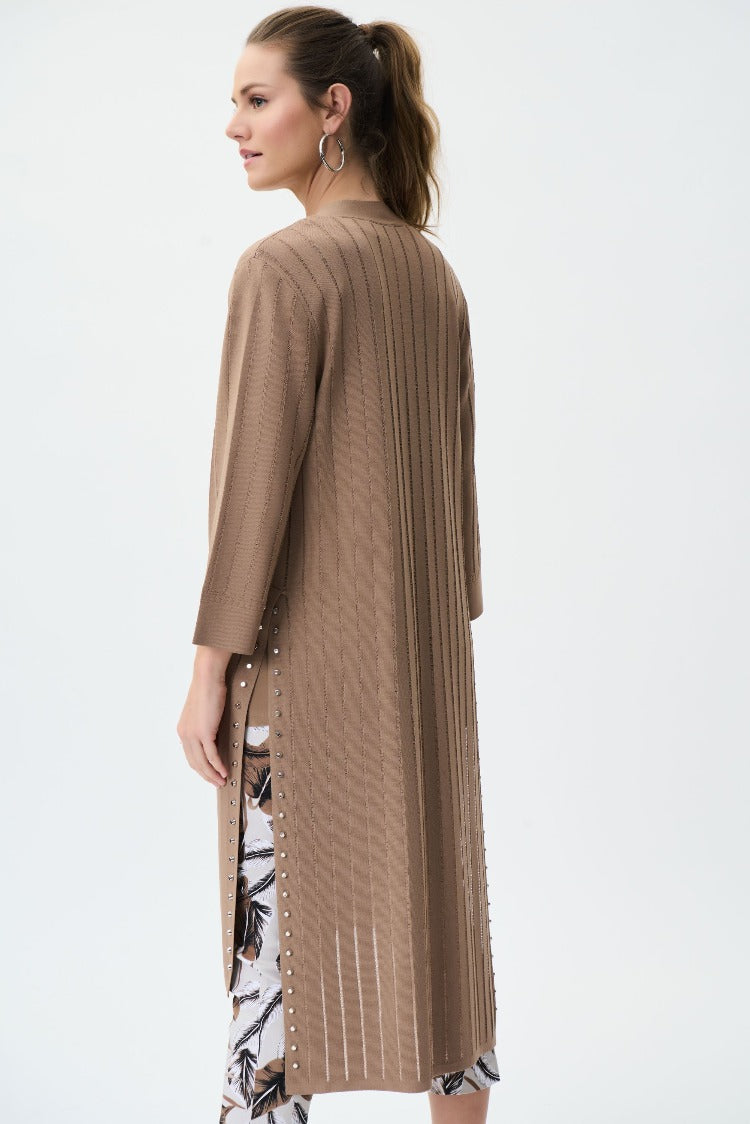 Comfortable and flattering this Joseph Ribkoff Long Cardigan will become a go to for you. The open front is perfect to show off your style and the side slits have studs along the edge for an edgy look that you can toss on over a casual or dressy style.