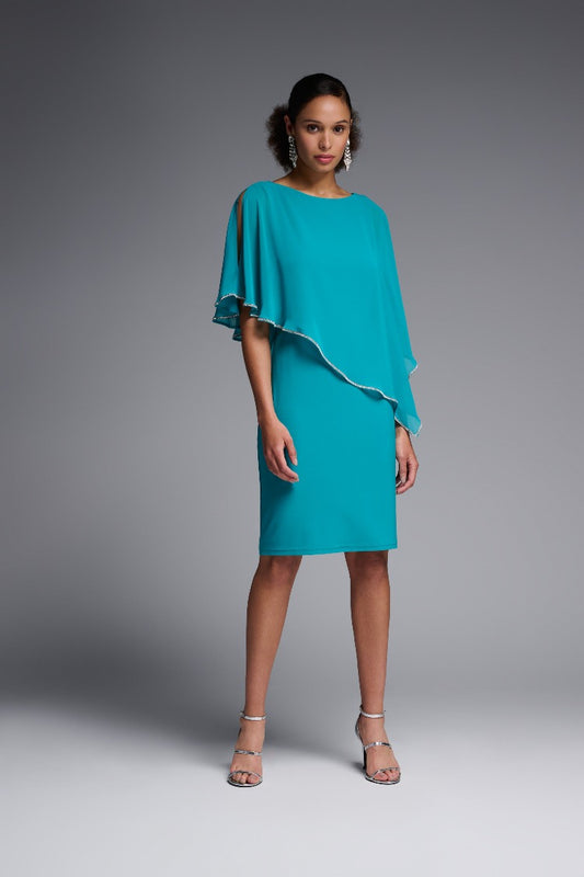 The flattering and feminine elegance of this Joseph Ribkoff Overlay Dress is the perfect choice for your special event. With striking asymmetrical chiffon overlay and rhinestone details, it gives you a fabulous striking silhouette.  