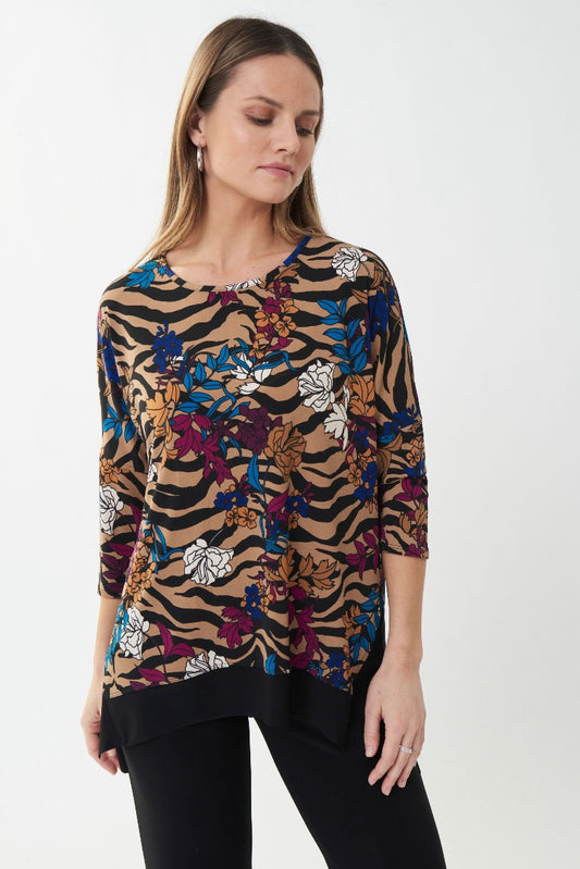 Make a statement in this Joseph Ribkoff Flower Top. Showcasing an attractive flower print with exotic tiger stripes, this top is finished with a round neckline, 3/4 length sleeves and a split, high-low hemline.