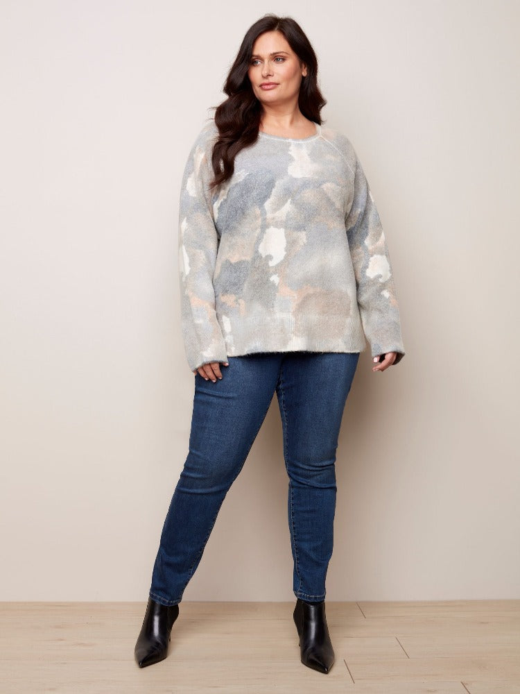 Get into your fashion groove with this tie-dye inspired Charlie B Plus Reversible Printed Crew Neck Sweater. This sweater is so versatile with a relaxed fit, roomy raglan sleeves and a classic crew neckline. The reversible option allows you to wear it inside and out!